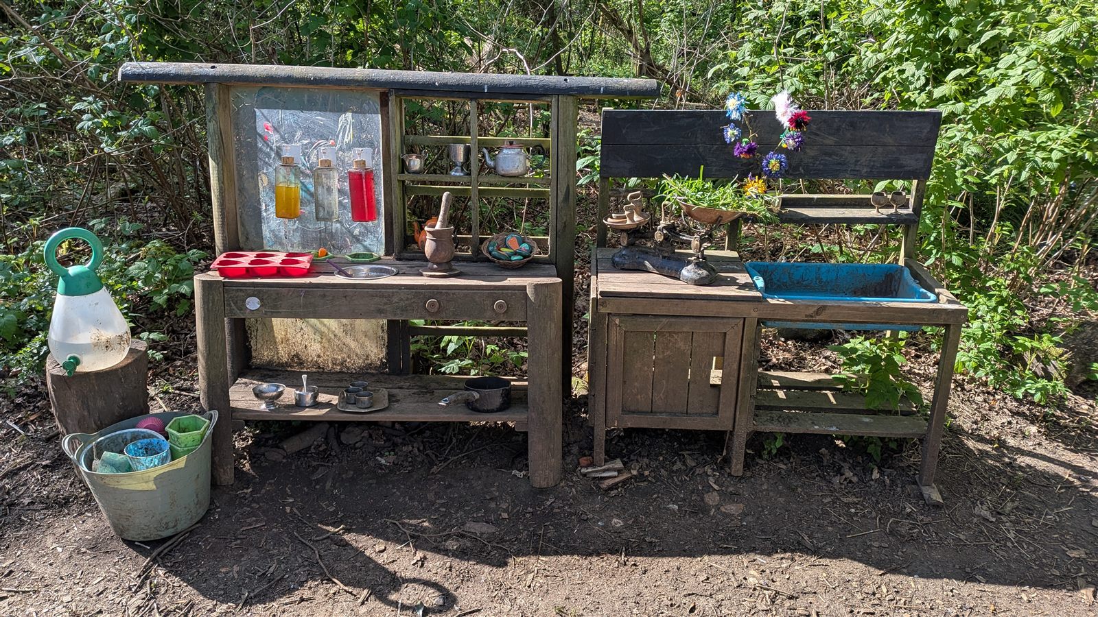 The woodland mud kitchen and play kitchen set up at our Forest School site