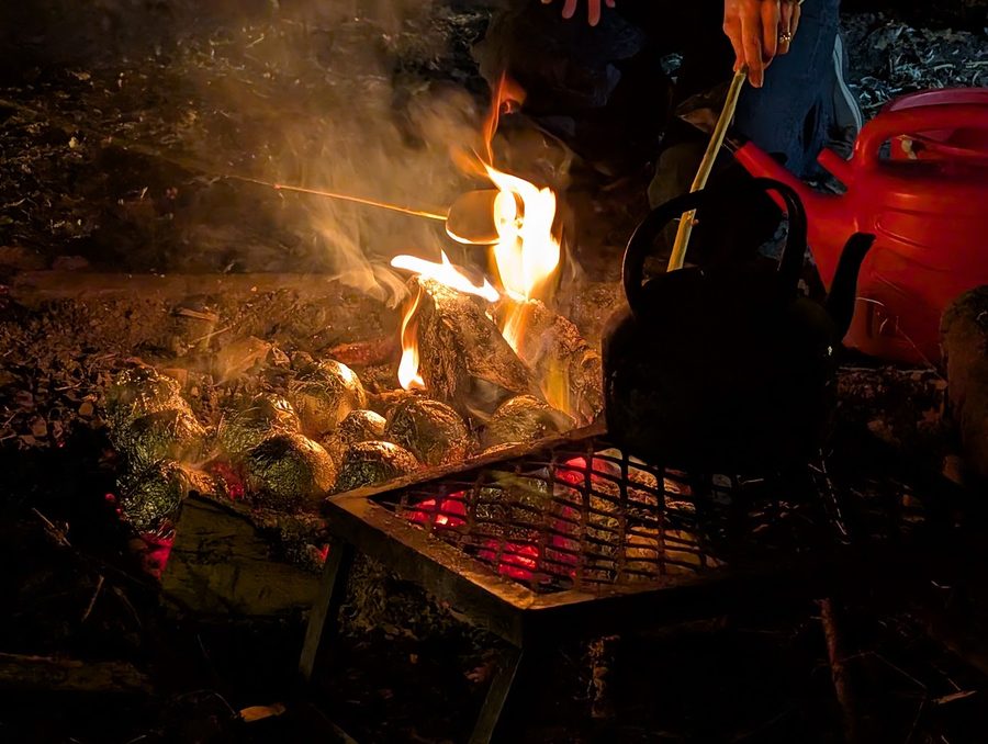 Chocolate oranges wrapped in foil, baking in the embers
